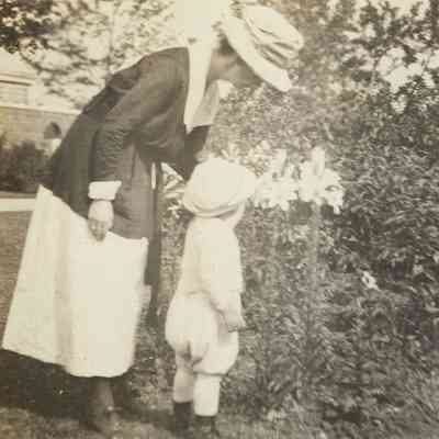 Mildred Wells Carton and Lawrence Carton, inspecting lilies