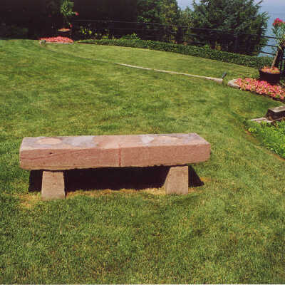 View of a red stone bench on the lawn of the Edward Byron Smith house