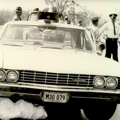 Police officers next to car