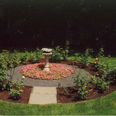 View of circular garden around a birdbath at Edward Byron Smith house