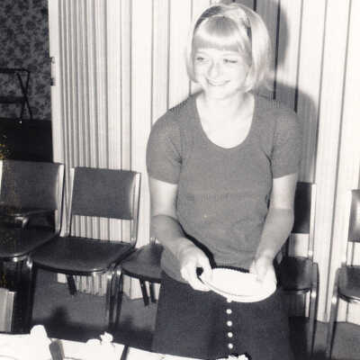 Young Woman Serves Herself a Piece of Cake