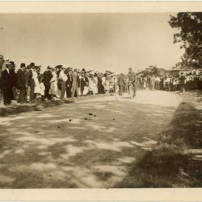 Bystanders and bicyclist on road