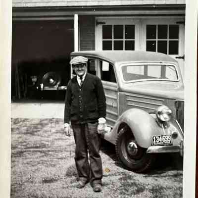 Enoch Dunn in front of Carton garage, c. 1940