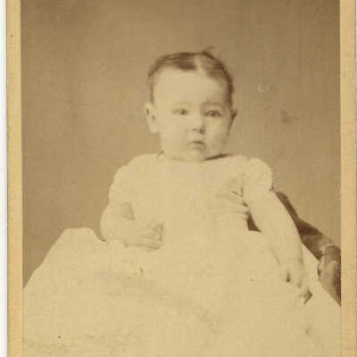 baby in a long white dress
