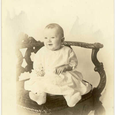 Baby sitting in large old chair