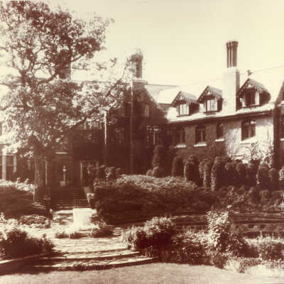 Exterior of White Oaks with stone walkway and shrubs