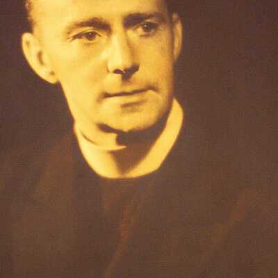Portrait of man in priest's coat and collar