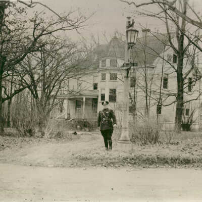 Police officer standing at corner of College Road and Illinois