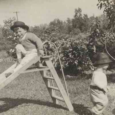 Toddlers Lawrence A. Carton and Robert W. Carton, c. 1921 on a slide