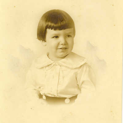 young child with dark short hair and bangs