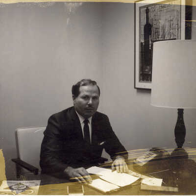 Unnamed Man Sits at Desk