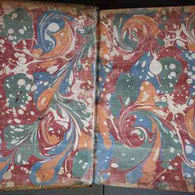 Marbling on Interior Cover: Marbled paper with colors red, white, blue, green, and yellow/orange. These pages are unique to this copy, as they could not have been replicated by nature of the technique of marbling.