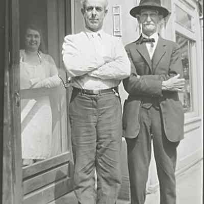 M. E. Hall center, Henry Clay Fleming right. A 6-1-29 photo taken by Clara shows the building in the background (next to the old bank on Walnut St) that she says was the "Photo Service Co" and labels "M E Hall." It is possible both Hall and Fleming were briefly in business together.