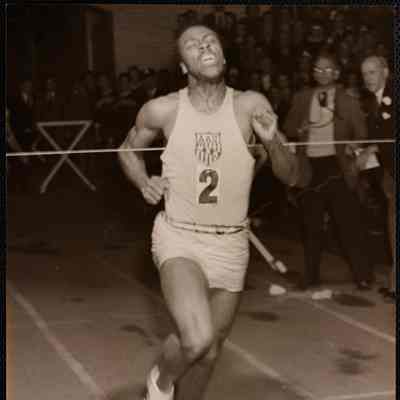 John Baricom smashing across the line in his record 1m 49.8s half-mile.