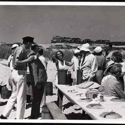 Siasconset clam bake Mrs Walter Caelius holding up bottle of scotch