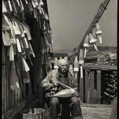 Painting lobster buoys - Maine. Port Clyde, ME