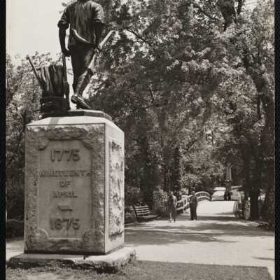 The Concord Minute Man. In the background is the "Rude Bridge" + the obelisk marks the spot where the first British soldier fell.