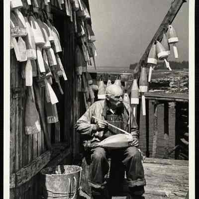 Painting lobster buoys - Maine. Port Clyde, ME
