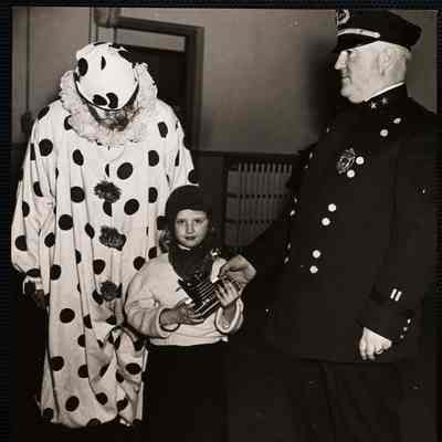 Halloween celebration. At Washington police sta. Roslindale. Florence Wilson won a camera - with Capt. Francis M. Tilman of sta. 17 West Roxbury.