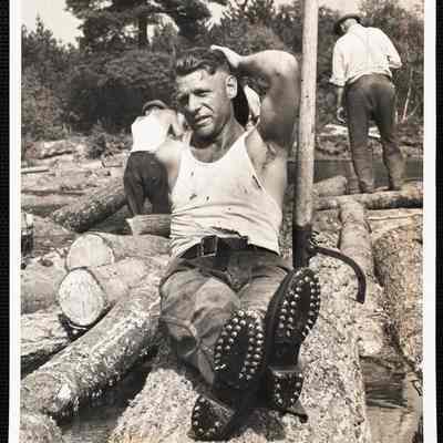 Wide World Photos Boston Bureau Logs go down the oldest logging river in the United States. Biddeford, Maine - Riding logs 90 miles down a river requires special footwear very different from the type used on the ballroom floor. Edward Burrill of Limington, Maine, one of the log drivers on the Saco River is here shown wearing his spiked shoes. The sharp spikes hold on the logs as the wearer runs from one log to another as they float down the river. (see main caption)