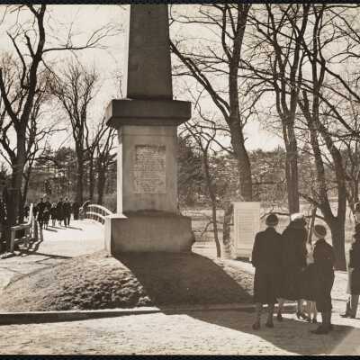 Obelisk which marks sport where first British soldier fell - in background is "Rude bridge" + Concord Minute Man.