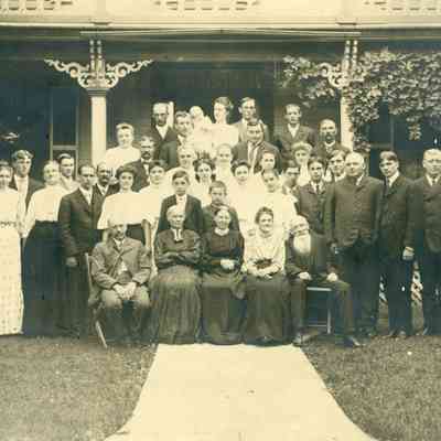 Back Row at Left is William Heywood. Women on very left is Sarah E. Heywood. Sitting in Front, 2nd from L is Helen E. Heywood.