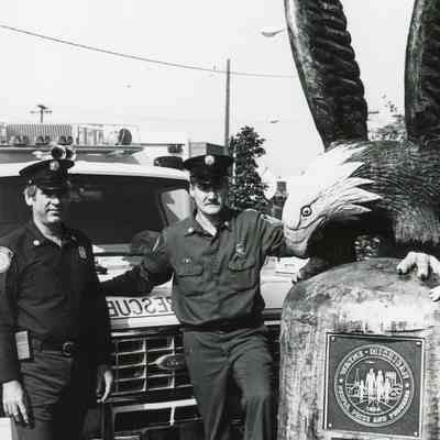 Molitar and Cuffillti by carved Eagle Statue