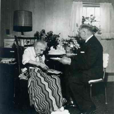 Estelle Bunting on her 100th birthday on March 9,1964 with Rev. Erwin A. Britton at the Clark Convalescent Home.