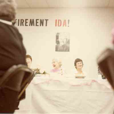 Ida Doletzky in the middle under her photo at her retirement party.