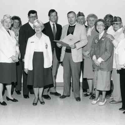 Mayor Pat Norton is in middle with book.
