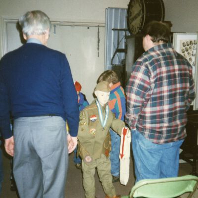 Henry Goudy showing Den leader Chuck Hall the boy scout uniform from long ago