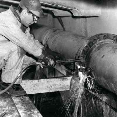 Al Cooper welding sewer pipe under Wayne road bridge 1956