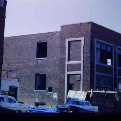 Building being torn down. Slide.