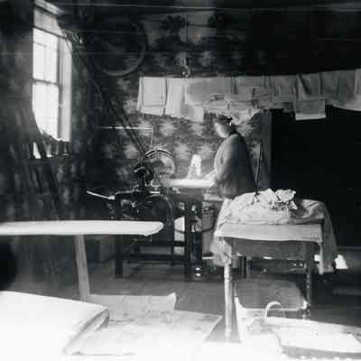 Maude in work room of laundry.