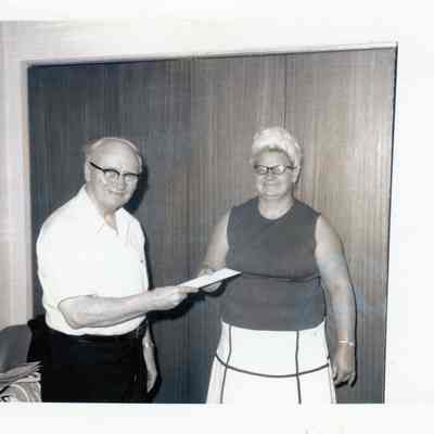 Fr. Haney presenting bond to Mrs. Virginia Turek