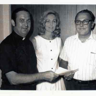 Fr. Romps, Ann Grayewski presenting Charles Grabys with savings bond