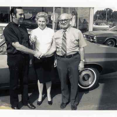 Fr. Romps with winners of Ford Torino, Mr and Mrs. Thomas Cataldo