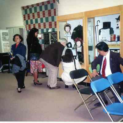 The director (Hank Goudy) showing the ladies from the Philippines victorian ladies' fashion.