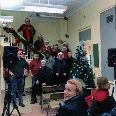 Carolers on the stairs in the museum