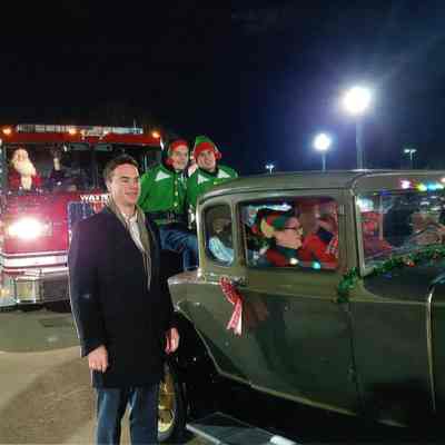 Firetruck and Model A car in parade, Kevin Coleman standing