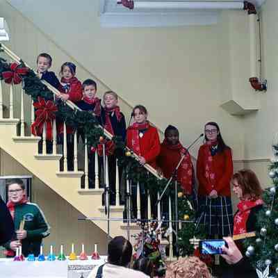 St. Joseph Catholic school Carolers on the stairs in the museum