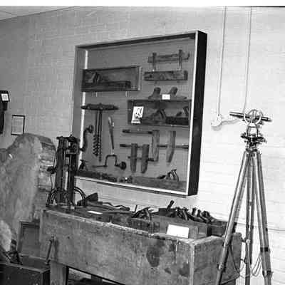 The 200 year slab of elm tree is right next to a workbench and tools.