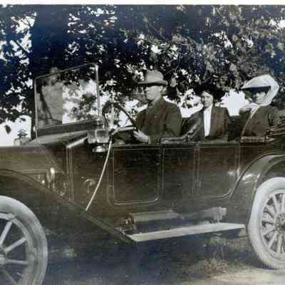 A man and two women in a car.