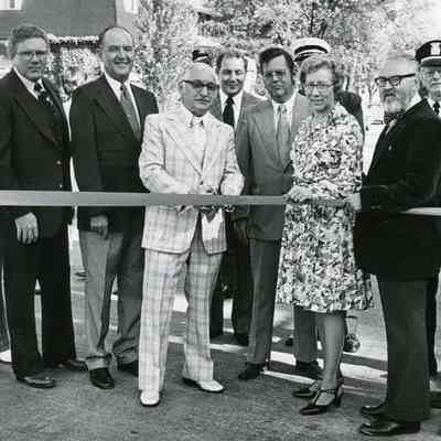 Second Street Bridge Opening Ceremony September 8, 1976. LtoR: Neil Prieskorn (Assistant Fire Chief), Dallas Keller (Superintendent of Public Works), Kenneth O. McKee (State Representative), Paul Lada (Mayor), Ray LeCornu (Director of Public Safety), Frank Simmons (Admin Assistant in Metro District OFC State Highways), Kenneth Warfield (Fire Chief), Geneva Ford (City Clerk), Edward E. Mahalak (State Rep), Herbert Haslam (Captain), Kurt M Heidmann (Councilman).