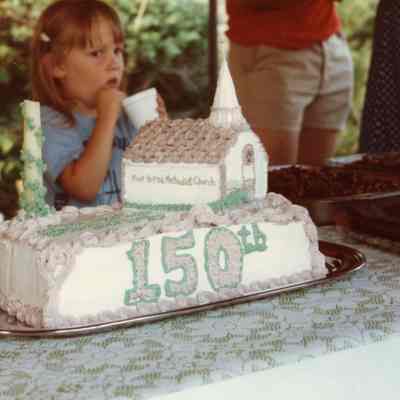 Salina Smith looking at the cake for the 150th Birthday Party on June 27, 1982.