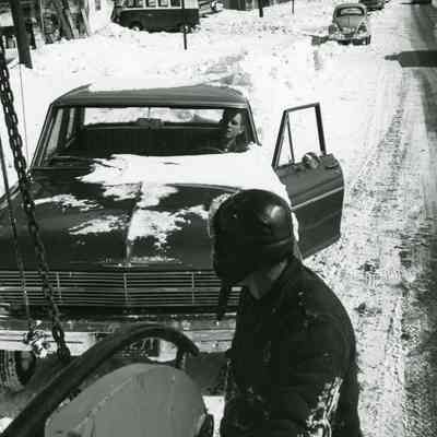 Car getting pulled from a snowbank 1965