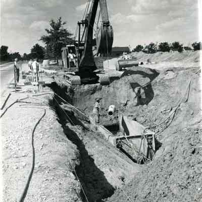 D.P.W workers digging for a drain.