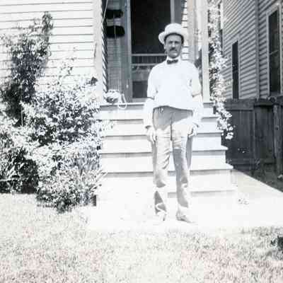A man and the back of his house.