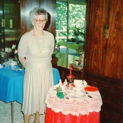 Garden Member standing by her Holiday table display.