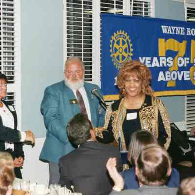 Harlan Whichalo giving Celestine Sanders the Paul Harris Pin.